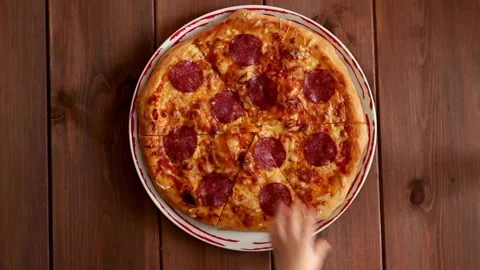Close-up Of human Hands Taking Slices of Pizza revealing green Video stock 132619435