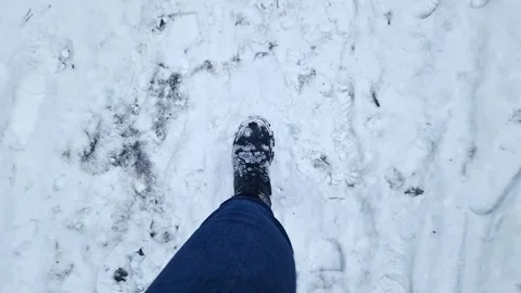 Close-up of human legs walking in snow Stock Footage 304990853
