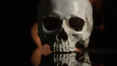 Close up human skull and fire on black background Video stock 143345290
