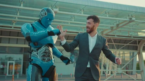 Close up humanoid robot having fun with man funny smilling on street in the city Stock Footage 133631029