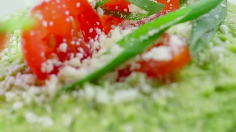 Close-up of Hummus with Tomato Garnish Stock-Footage 75758781