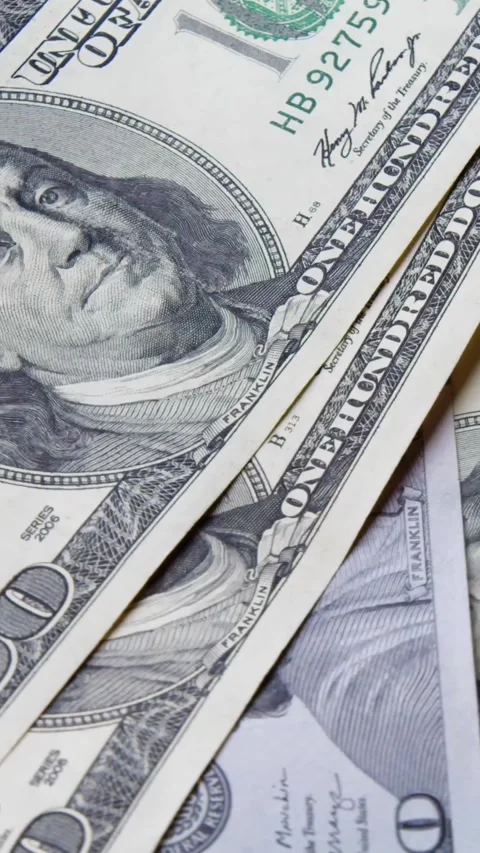 Close-Up Hundred Dollar Bills Dropping On Rotating Surface Illustrates Abundance Stock Footage 315538687