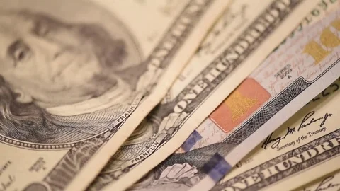 Close up hundred dollar bills into focus then out Stock Footage 75763574