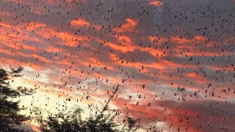 Close-up of hundreds of raindrops on a glass surface reflecting a spectacular Stock Photos