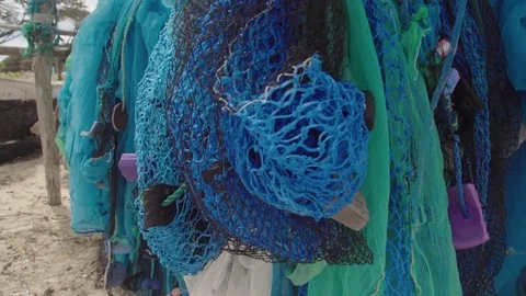 Close up of hung fishing nets on beach in Madagascar Stock Footage 85060909