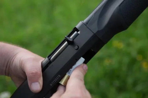 Close up of a hunter loading his weapon Stock Photos