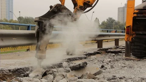 Close-up of hydraulic arm hammer breaks the asphalt on the road Stock Footage 86332546