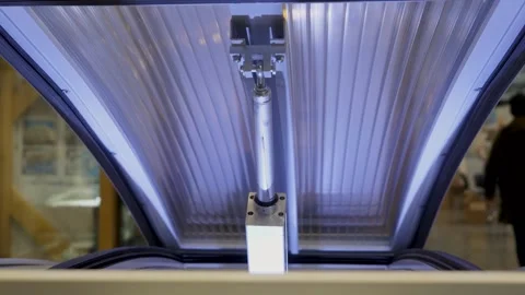 Close up of hydraulic mechanism opening automatically a horizontal big lid of an Stock Footage 153471737