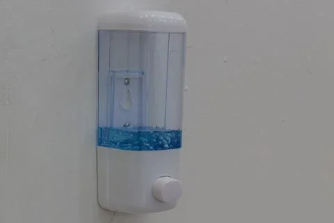 Close-up of hygienic push-button manual dispenser apparatus with transparen.. Stock Photos