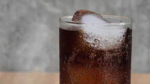 Close-up of ice and a soft drink on a wooden table. Stock Footage 311643037