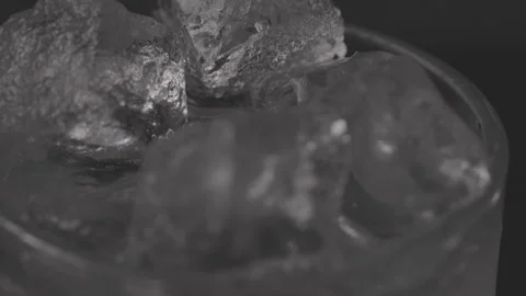 Close up of Ice cubes in drink, rotating glas Stock Footage 242156968