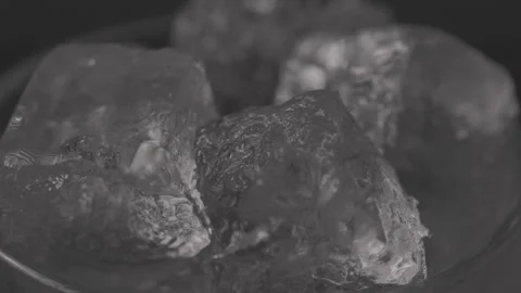 Close up of Ice cubes in drink, rotating glas Stock Footage 242157076