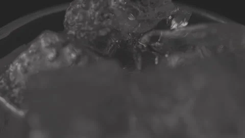 Close up of Ice cubes in drink, rotating glas Stock Footage 242157129