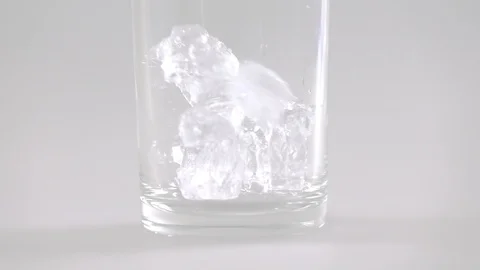 Close up of ice cubes falling into glass slow motion Stock Footage 102216091