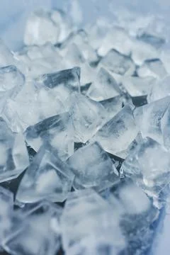 Close-up of ice cubes in freezer tray with cold blue tones Stock Photos