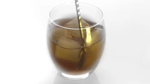 Close-up. Ice cubes rotating and melts in a glass of whiskey. Video stock 125379451