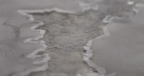 Close up of ice on a river with tiny opening and water flowing in slow motion Stock-Footage 150487557