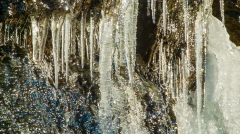 Close-up of Ice Stalactites and Icicles Melting from Mountain Stone Video stock 32669956