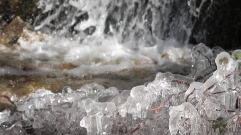 A close-up of ice with water splashing into a pool behind it in the Valle de la Stock Footage 293713638