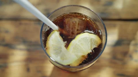 Close up of iced cola drink with lemon slices and bubbles in transparent glass Stock Footage 337199867