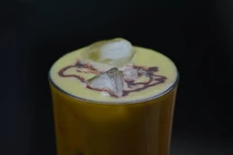 Close up of iced mango drink with ice on dark background Stock Photos
