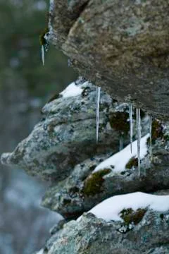A close up of the icicles on rocks. Stock Photos