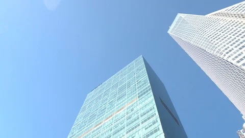 CLOSE UP: Iconic 1 WTC building reflecting in glassy skyscraper on sunny day Stock Footage 71636617