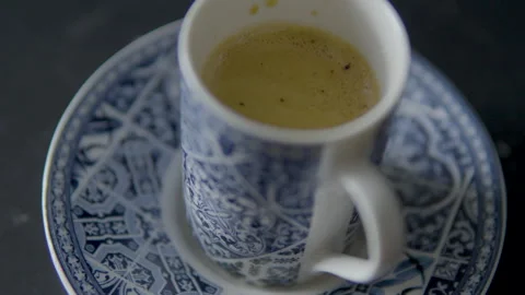 Close-up of the iconic cup with Portuguese patterns. Coffee served in a Stock Footage 245431016
