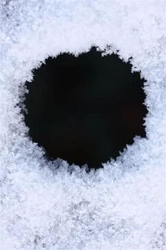 Close-up of icy snow texture frames round aperture for winter background Stock-Fotos