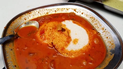 Close up of idly with spicy curry served on table.South Indian breakfast Id.. Stock Footage 313380951