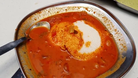 Close up of idly with spicy curry served on table.South Indian breakfast Id.. Stock Footage 313381055