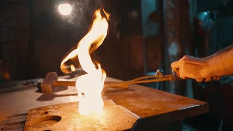 A close-up of the ignition of an oxy-fuel burner by a production worker. Stock Footage 225462450