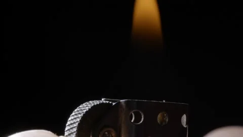 Close up ignition of zippo lighter macro studio shot isolated on black Stock Footage 235659510