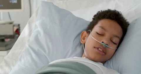 Close up of ill african kid having fever sleeping in bed at hospital Stock Footage 149312073