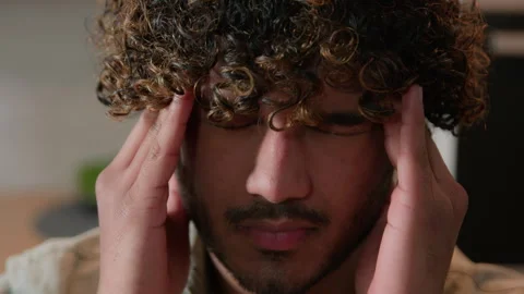 Close up ill Indian man massaging head pain ache blood pressure business problem Stock Footage 240991409
