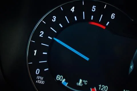 Close up of illuminated car tachometer on dashboard Stock Photos