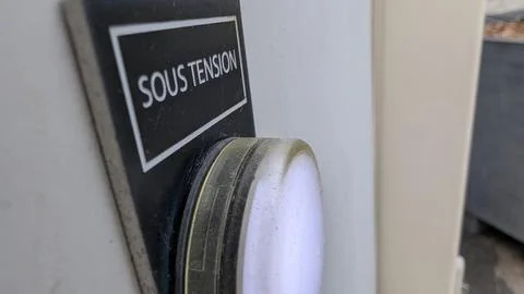Close-up of an illuminated energized indicator light on an industrial panel Stock Photos
