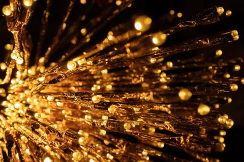 Close-up of illuminated golden string lights in a radial pattern, creating a  Stock Photos