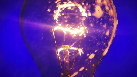 Close Up of Illuminated Light Bulb covered in soapy foam with bubbles Video stock 329762469