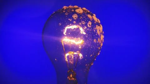 Close Up of Illuminated Light Bulb covered in soapy foam with bubbles Fotos de archivo