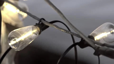 Close Up of Illuminated String Lights With Glowing Bulbs and Electrical Wiring 動画素材 337455862