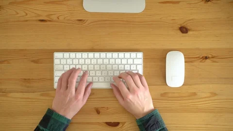 Close up image from above of man typing at keyboard. Video stock 128773932