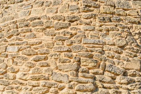 Close-up image of an aged, beige brick wall in a Central European village, .. Stock Photos
