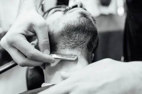 Close up image of barber makes beard cut of a man Stock Photos