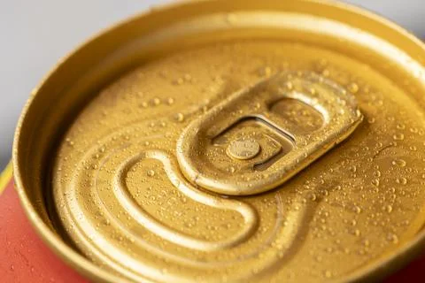 Close-up image of a beer can with multiple drops of water, the can is gold .. Stock Photos
