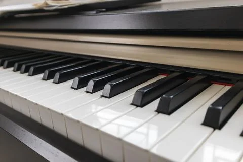 A close-up image of a black and white piano keyboard shows the surface deta.. Stock Photos