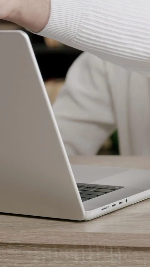 Close-up image of a boys hands opening a modern computer in an office on a desk Stock Footage 316605164