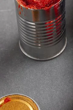 Close up image of a can of tomato paste which was just opened and the cap was Stock Photos