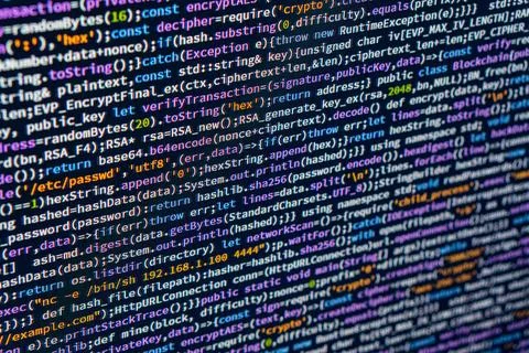 A close-up image of a complex C code snippet, with long lines of colorful t.. Foto stock