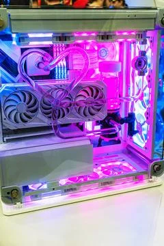Close-up image of a computer towers internal components, illuminated by pink  Stock Photos